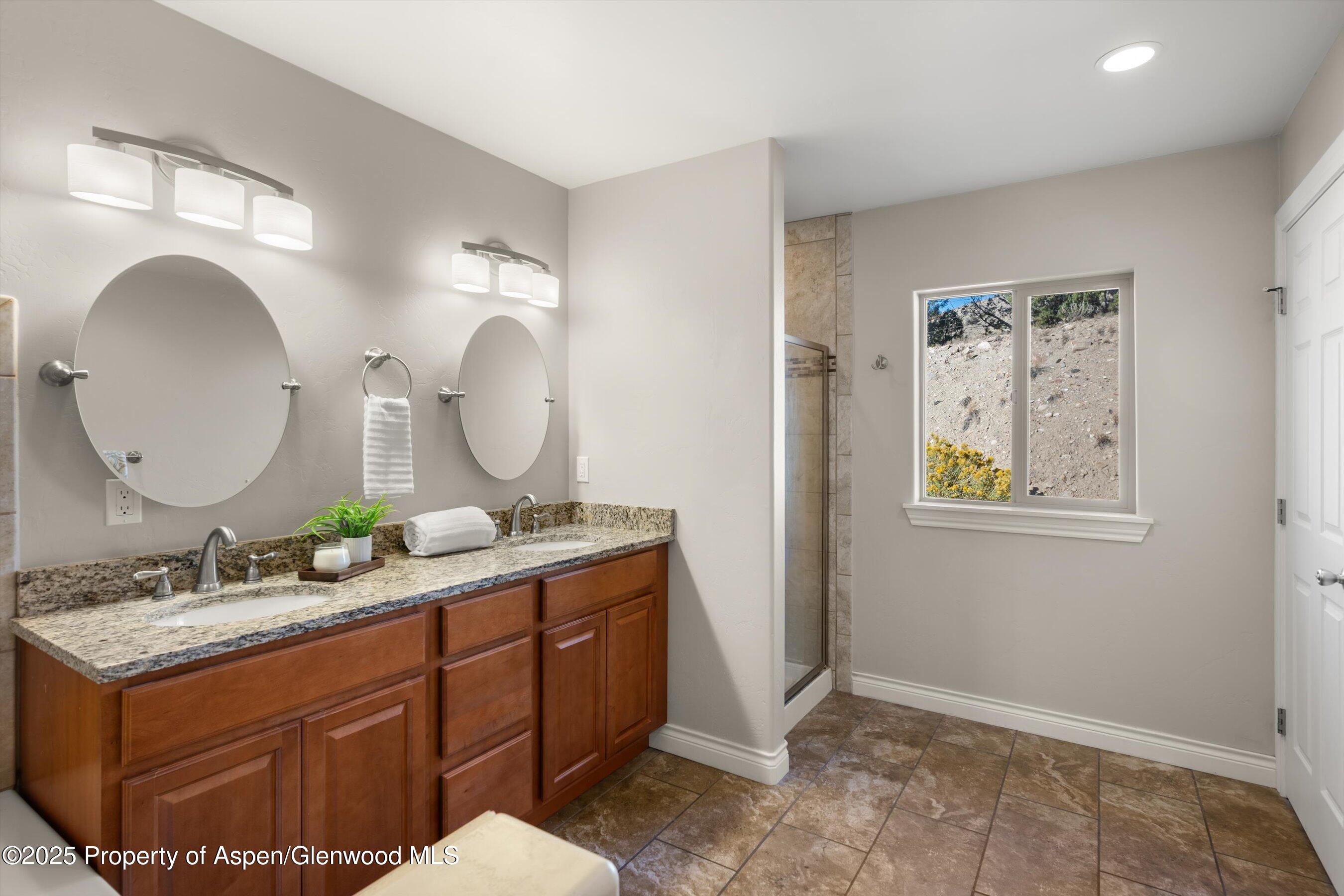 200 Castle Ridge Drive New Castle, CO 81647 - Photo 14 of 24 a bathroom with a granite countertop double vanity sink and a mirror