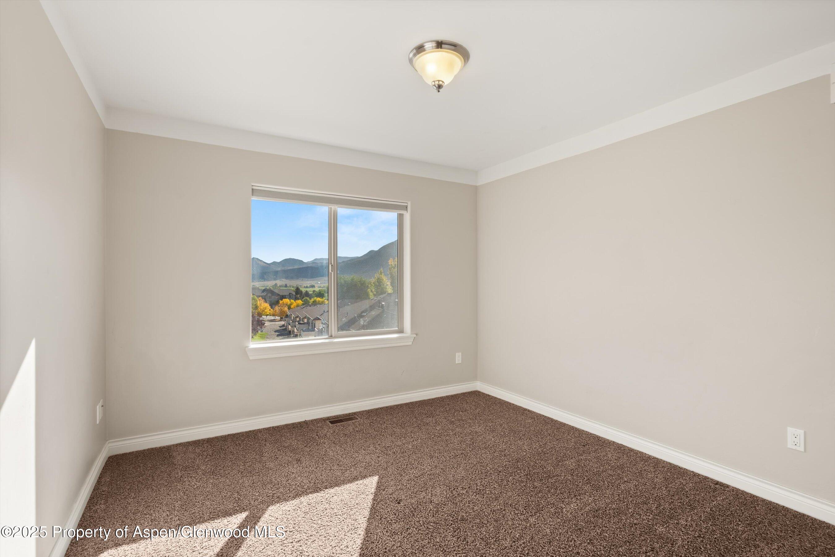 200 Castle Ridge Drive New Castle, CO 81647 - Photo 21 of 24 an empty room with windows