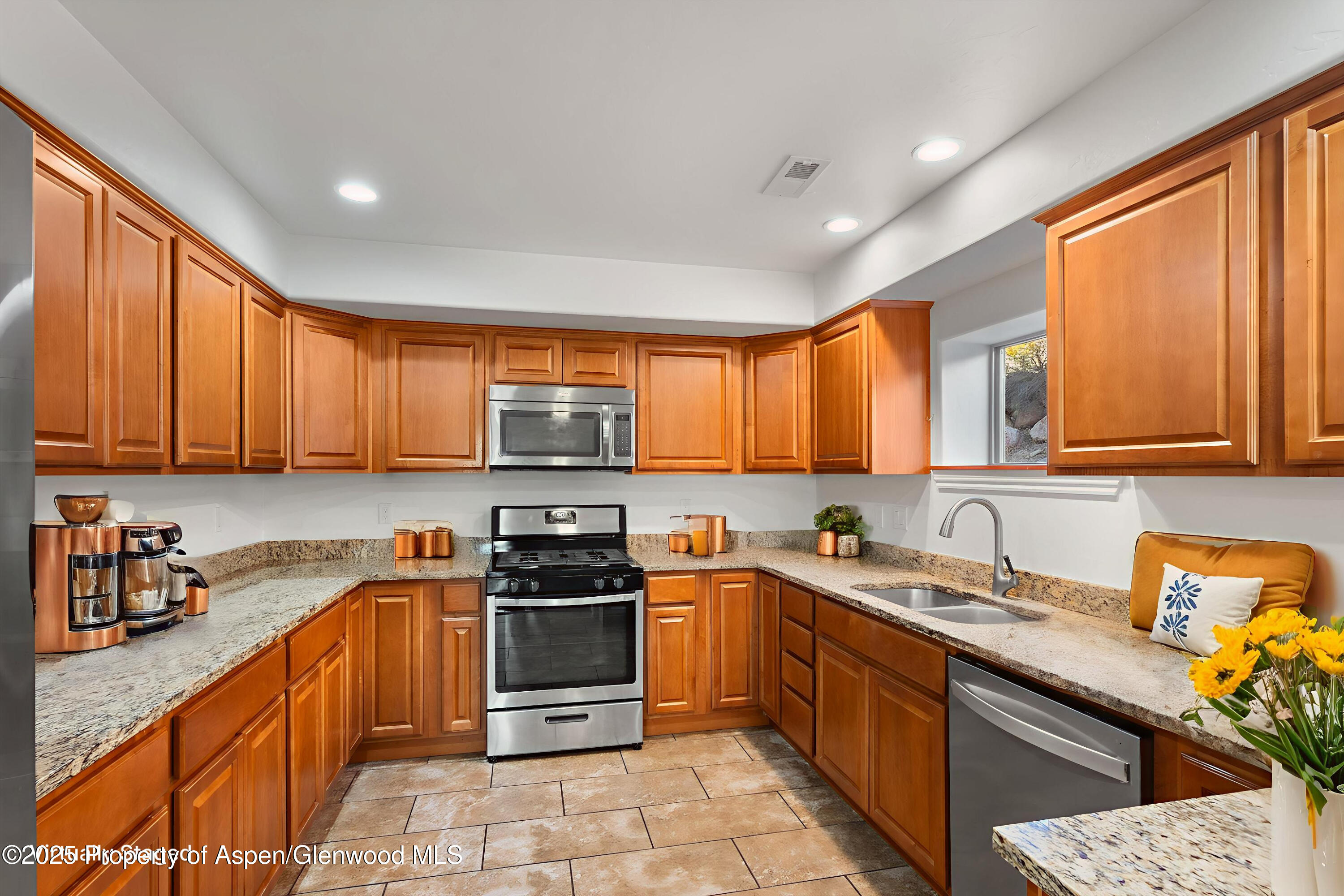 200 Castle Ridge Drive New Castle, CO 81647 - Photo 3 of 24 a kitchen with stainless steel appliances granite countertop wooden cabinets a sink dishwasher a stove and a refrigerator with wooden cabinets