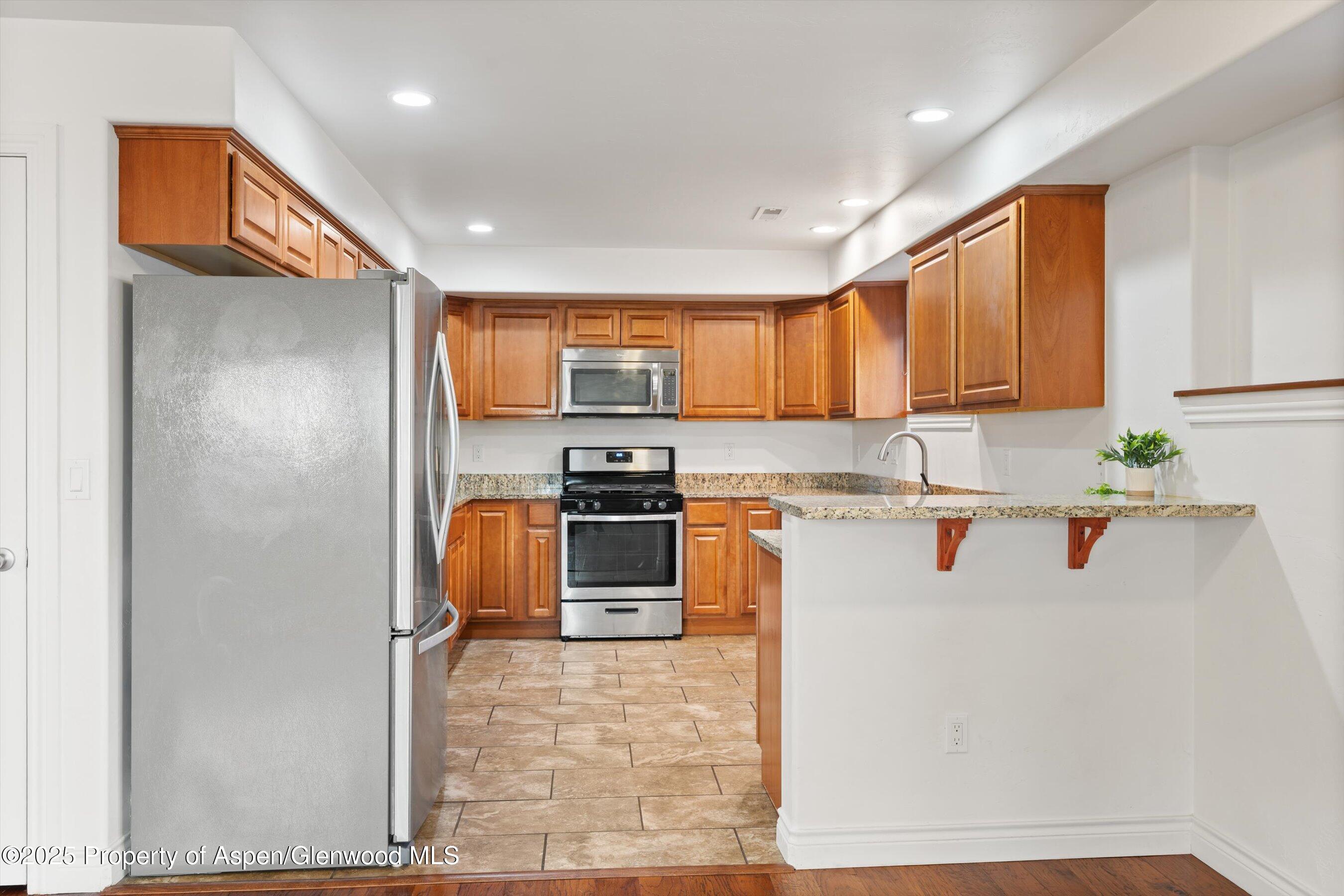 200 Castle Ridge Drive New Castle, CO 81647 - Photo 7 of 24 a kitchen with stainless steel appliances granite countertop a refrigerator a stove top oven a sink and dishwasher