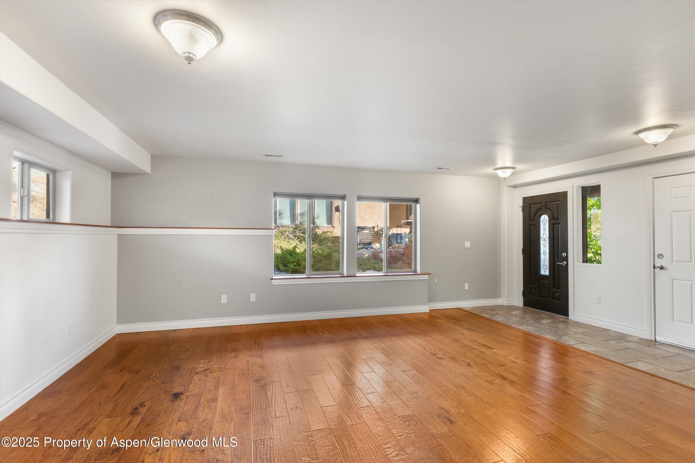 200 Castle Ridge Drive New Castle, CO 81647 - Photo 10 of 24 wooden floor in an empty room with a window