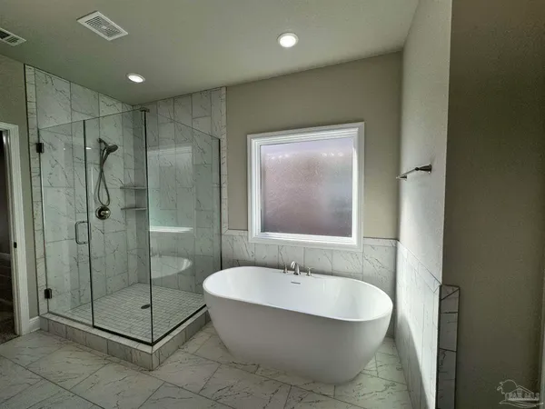 a bathroom with a glass shower door and a sink