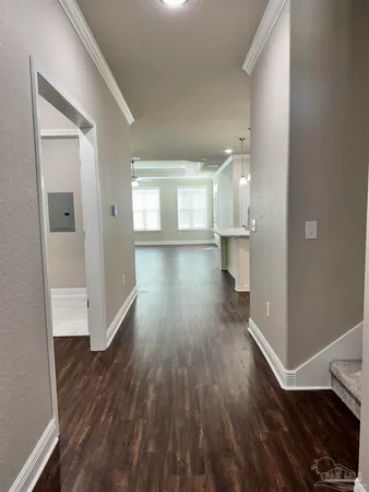 a view of a room with wooden floor and a window