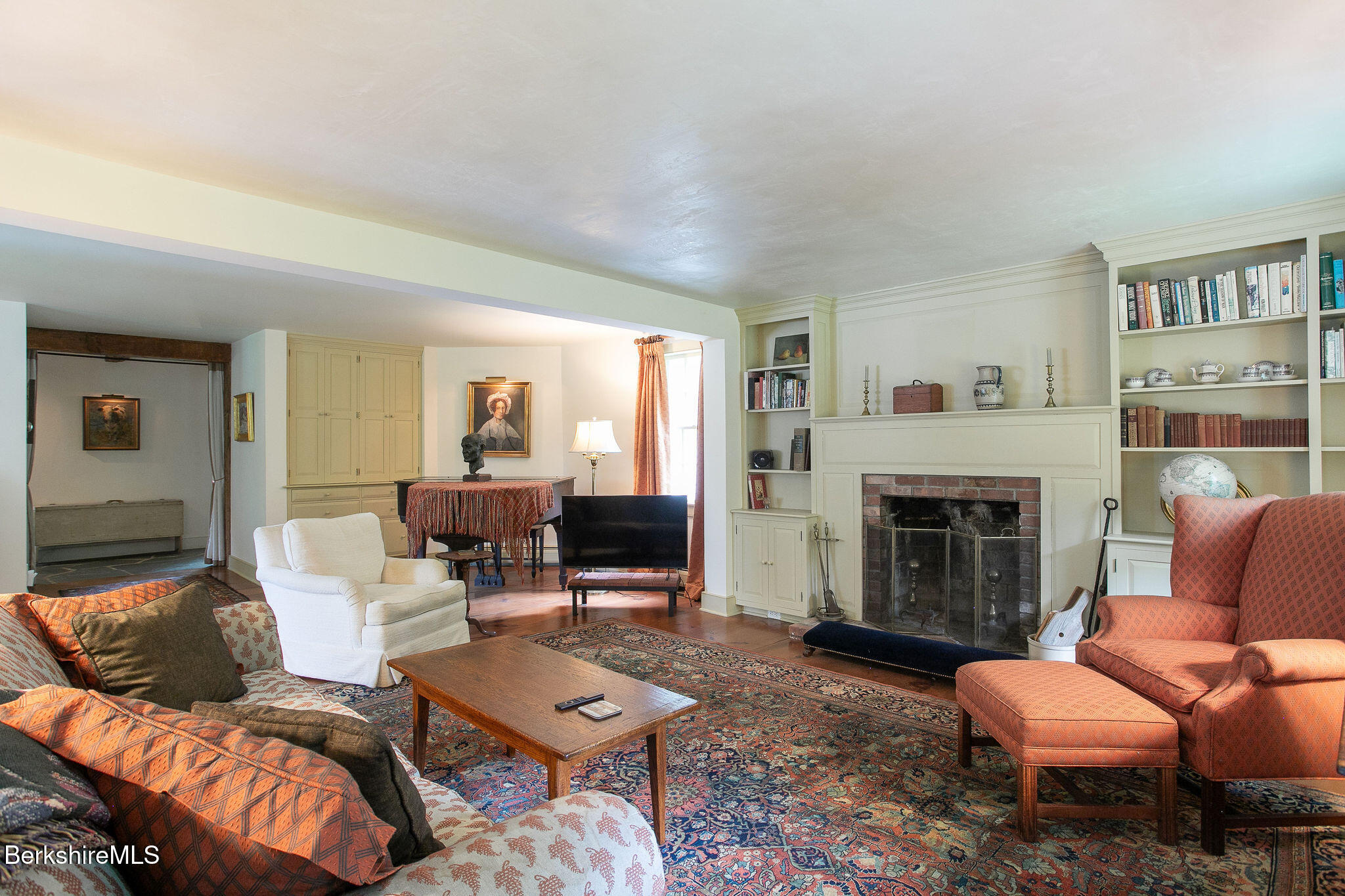 Undisclosed Address West Stockbridge, MA 01236 - Photo 15 of 61 a living room with furniture a fireplace and a bookshelf