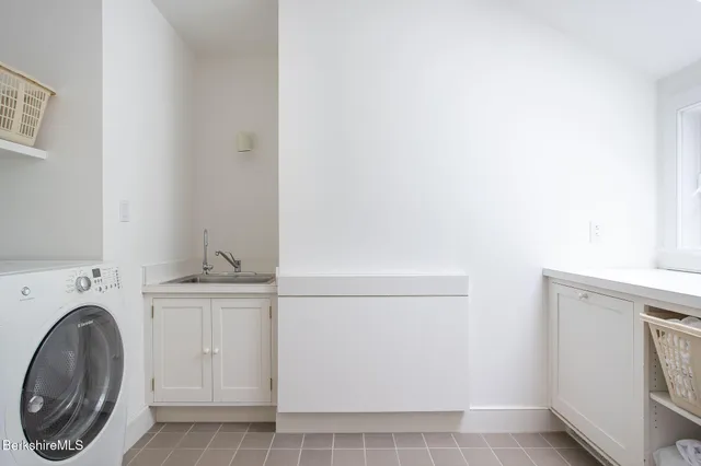 a bath tub sitting in a bathroom next to a window