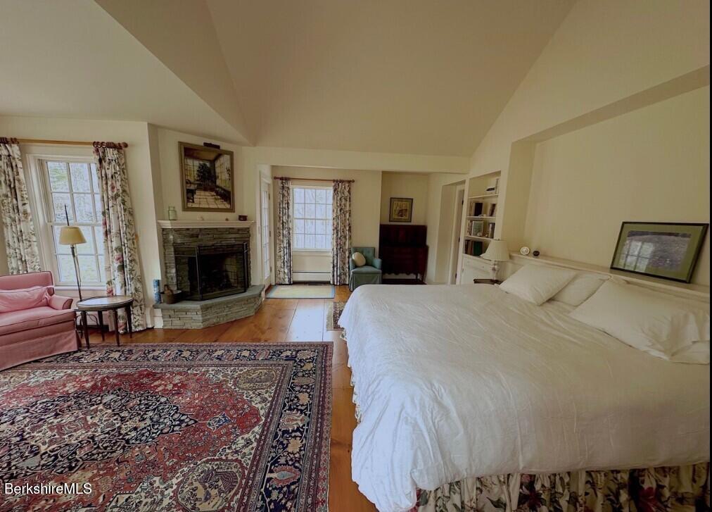 Undisclosed Address West Stockbridge, MA 01236 - Photo 29 of 61 a bedroom with a large bed and a fireplace