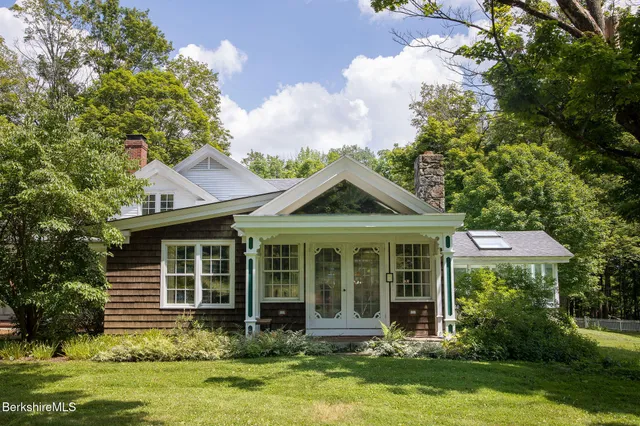 a swimming pool with outdoor seating and trees