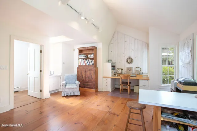a living room with furniture and floor to ceiling window