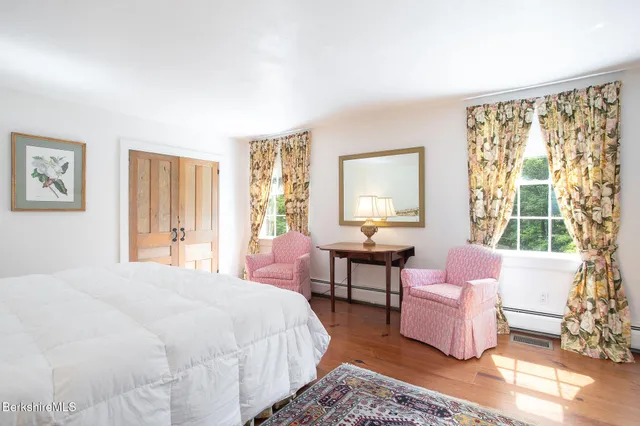 a spacious bedroom with a bed and a couch