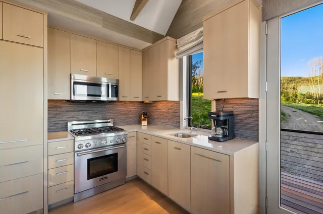 a kitchen with a stove microwave and sink