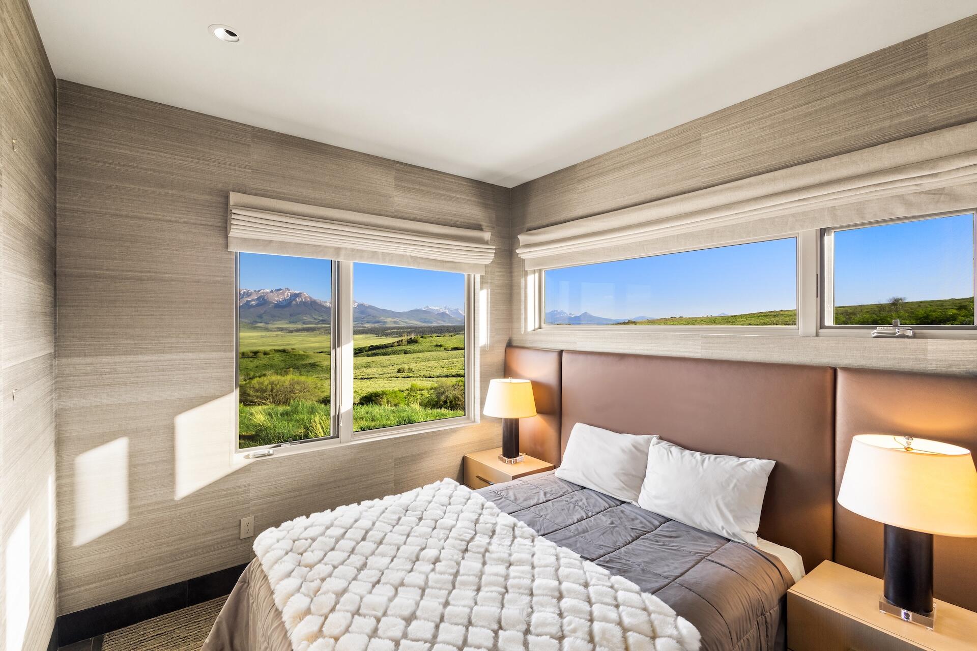 3362 Ranch Road Ridgway, CO 81432 - Photo 17 of 40 a bedroom with a large bed and a window