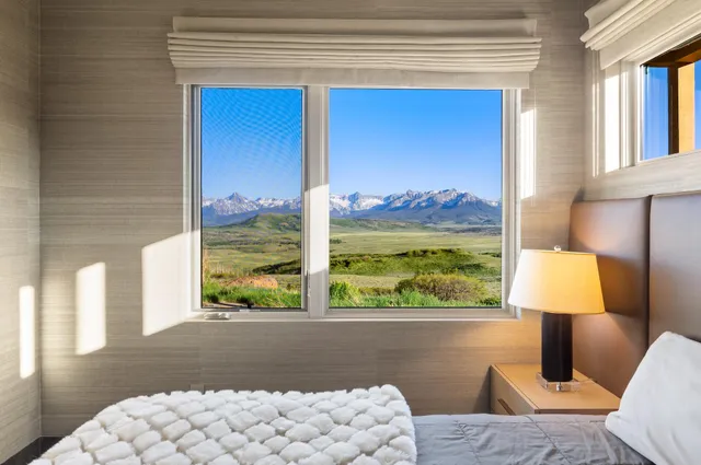 a living room with a large window and couch