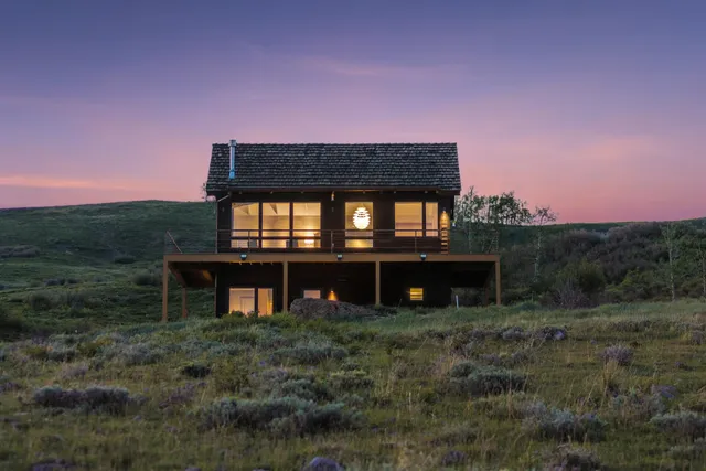 a view of a big house with a yard