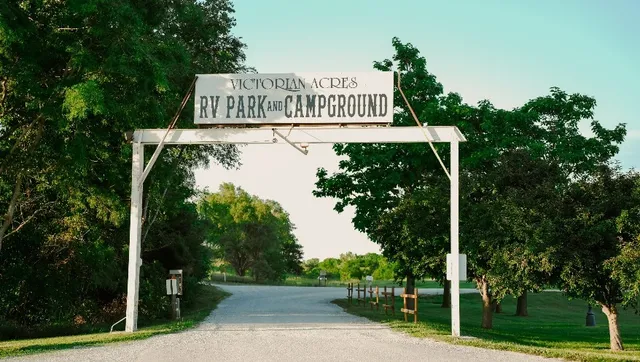 a front view of a house with a yard and large trees