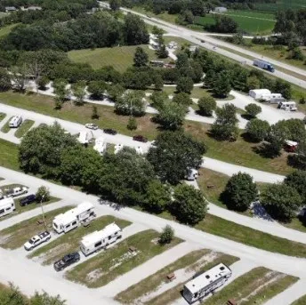 a view of swimming pool with seating area and trees in the background