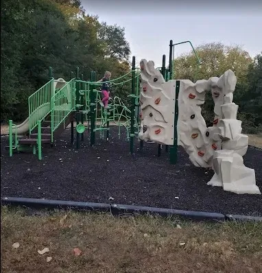 a view of a park with benches and lake view