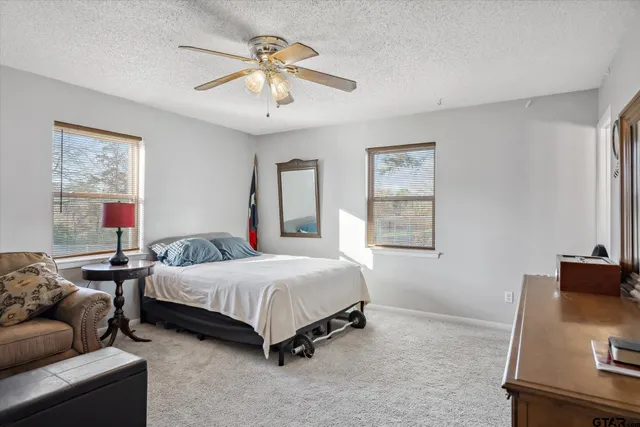 a bedroom with a bed window and a couch