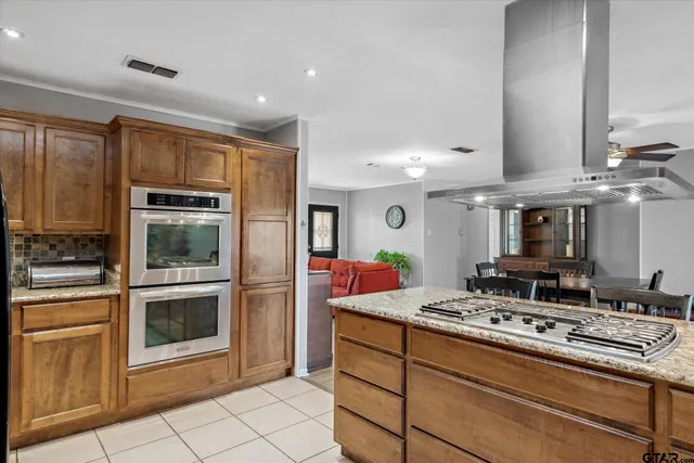 a kitchen with stainless steel appliances granite countertop a stove and a sink