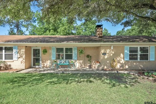 a front view of a house with outdoor seating