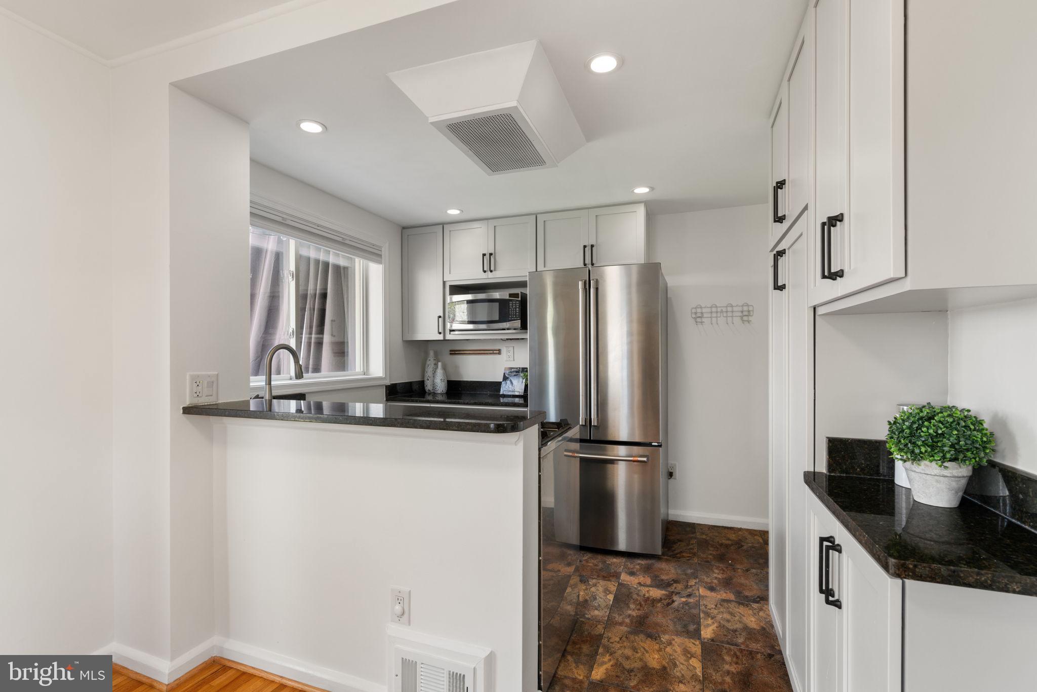 6021 Williamsburg Road Alexandria, VA 22303 - Photo 13 of 44 a kitchen with stainless steel appliances a refrigerator sink and stove