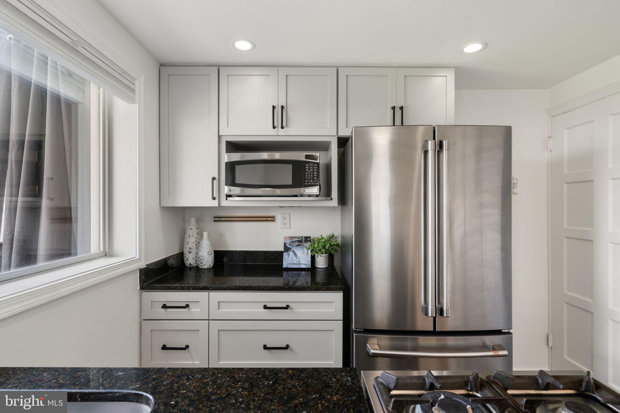 6021 Williamsburg Road Alexandria, VA 22303 - Photo 18 of 44 a kitchen with appliances a refrigerator and cabinets