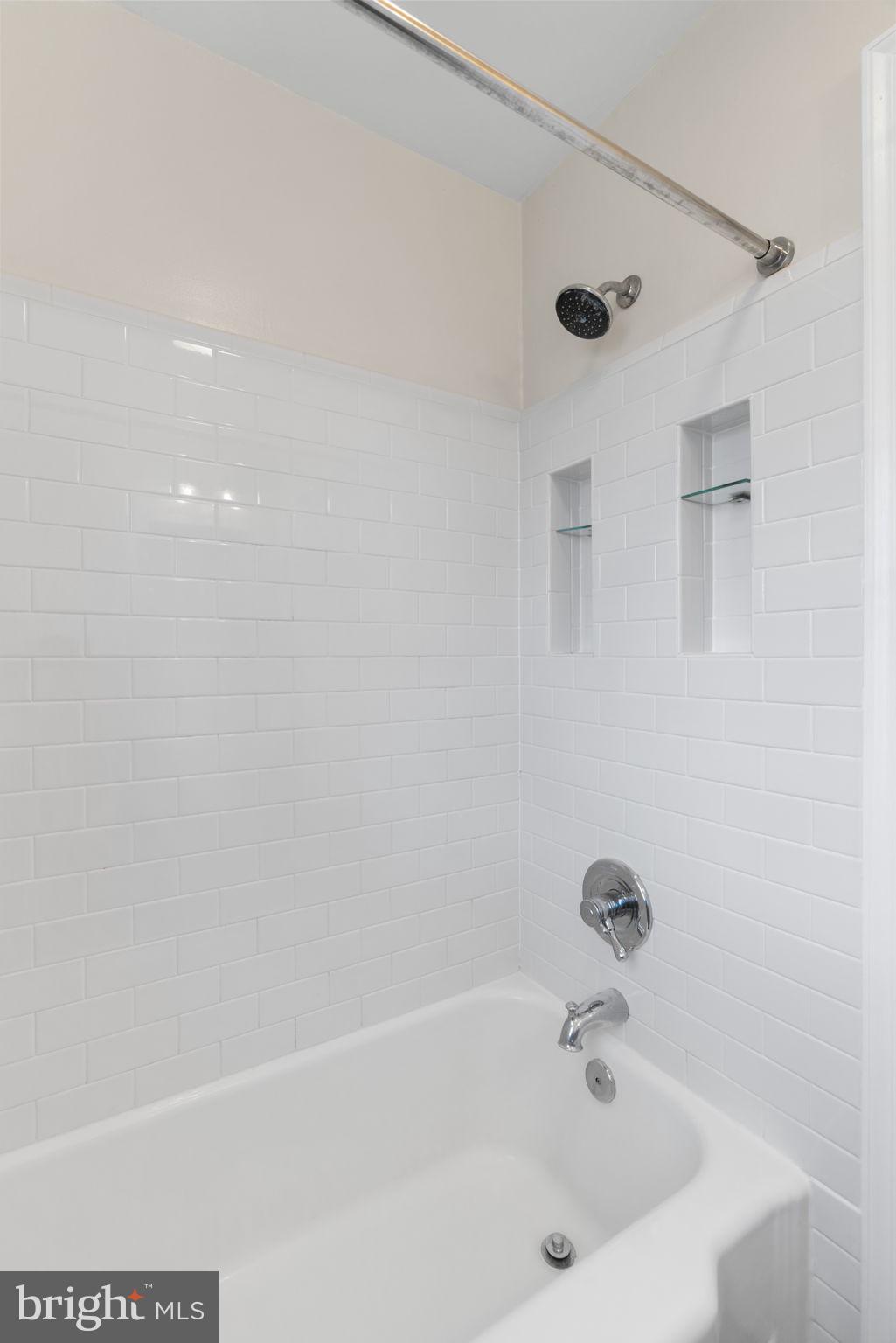 6021 Williamsburg Road Alexandria, VA 22303 - Photo 25 of 44 a bathroom with a tub and a shower