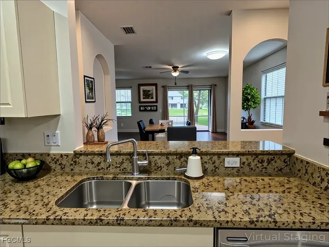 a kitchen with stainless steel appliances granite countertop a sink and a granite counter tops