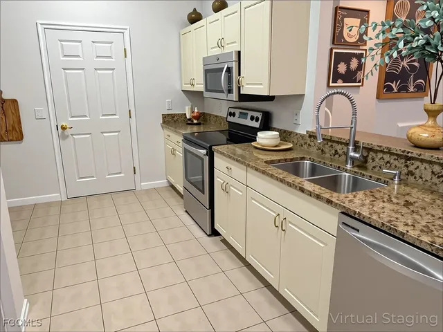 a kitchen with granite countertop a sink a stove and cabinets