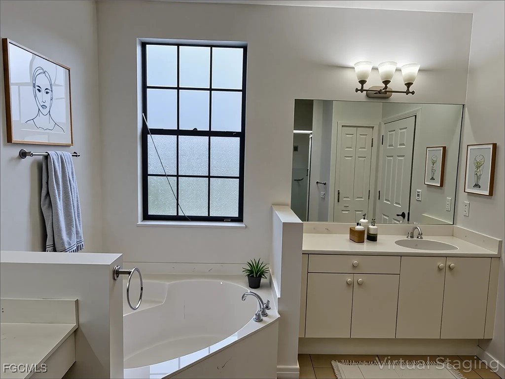 14764 Pinnacle Place Naples, FL 34119 - Photo 3 of 15 a bathroom with a double vanity sink a mirror a bathtub and window