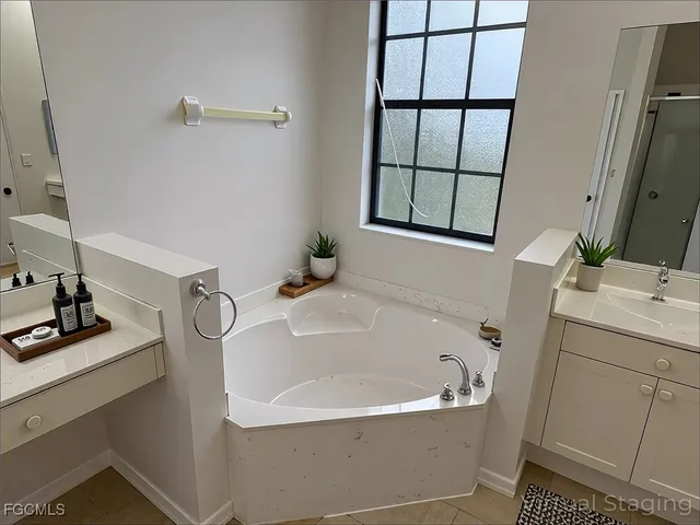 a bathroom with a sink a window and mirror