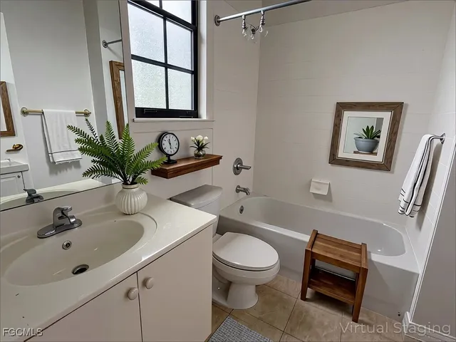 a bathroom with a sink mirror and toilet