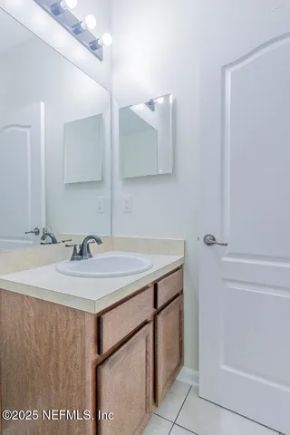 a view of a house with a yard and a large tree