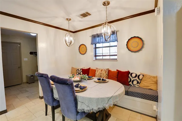 a view of a dining area with furniture and a chandelier