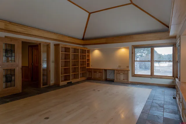 a view of an empty room with a fireplace and a window