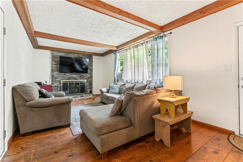 154 Central Road Tarrs, PA 15688 - Photo 11 of 24 a living room with furniture a fireplace and a flat screen tv