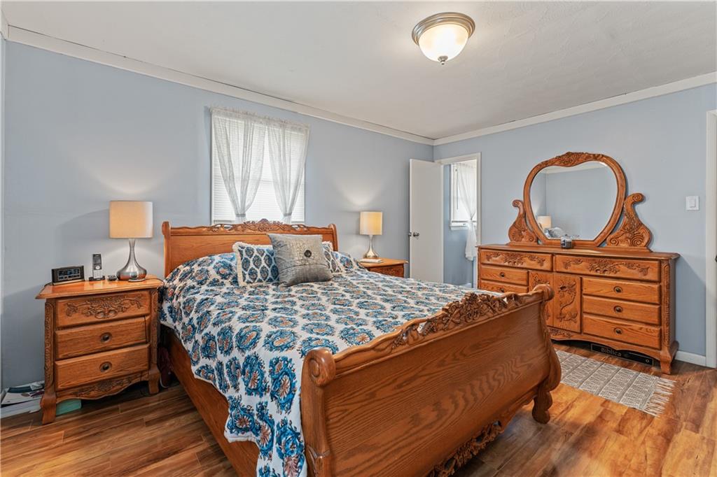 154 Central Road Tarrs, PA 15688 - Photo 15 of 24 a bedroom with a bed and wooden floor