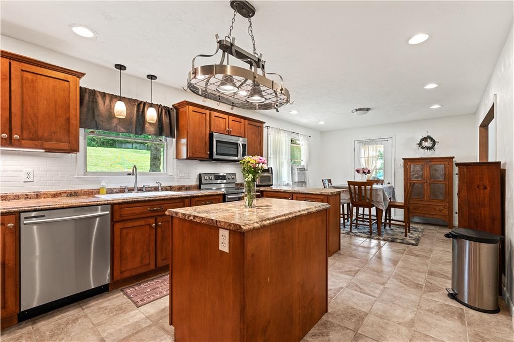 154 Central Road Tarrs, PA 15688 - Photo 10 of 24 a large kitchen with stainless steel appliances granite countertop a sink a stove and a refrigerator