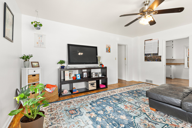 372 800 East Provo, UT 84606 - Photo 5 of 29 Bright living area featuring wood-finish flooring, a ceiling fan with integrated lighting, and white walls