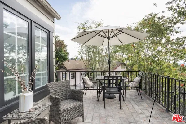 a view of balcony with furniture and umbrella