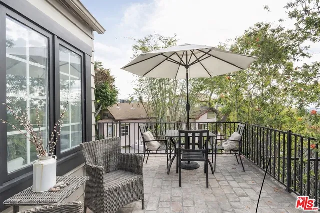 a view of balcony with furniture and umbrella