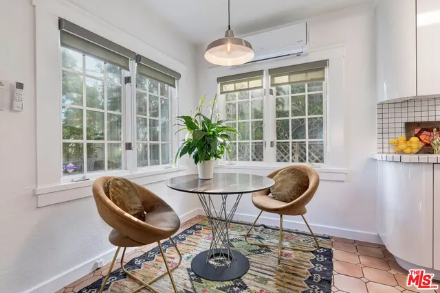 a dining room with furniture and window