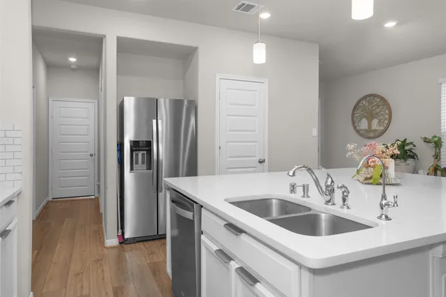 a kitchen with a sink and a refrigerator