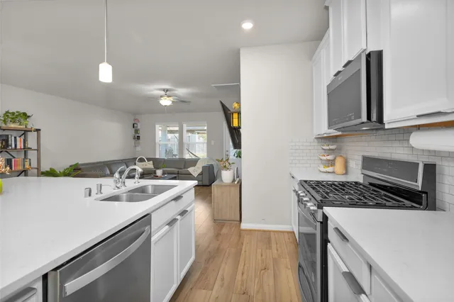 a kitchen with a sink stove and microwave