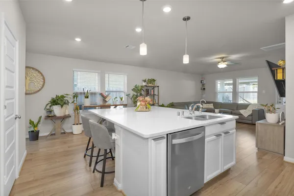 a kitchen with a table chairs stove and wooden floor
