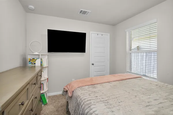 a bedroom with a bed and a flat screen tv