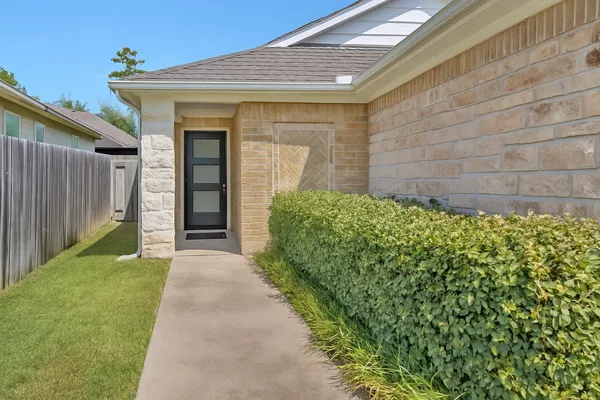 a view of a house with a small yard