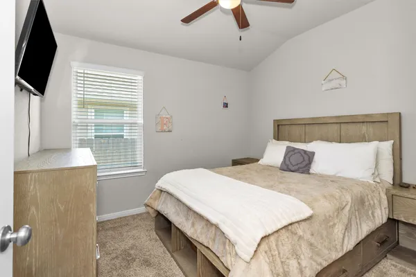 a bedroom with a bed and a flat tv screen