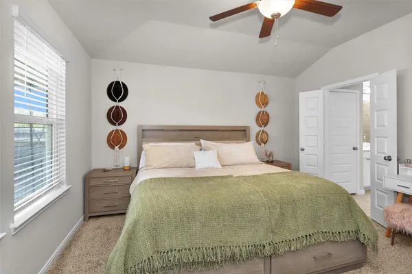 a bedroom with a bed and window with the shoe rack