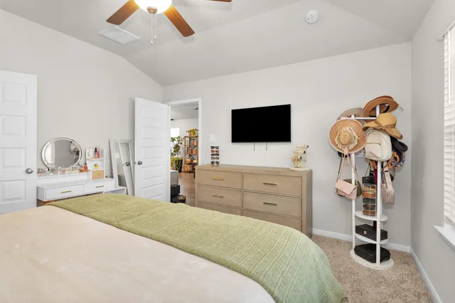 a bedroom with a bed and flat screen tv