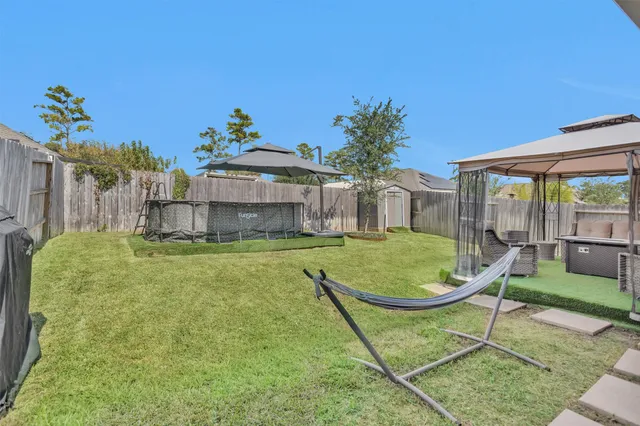 a view of a house with backyard and sitting area
